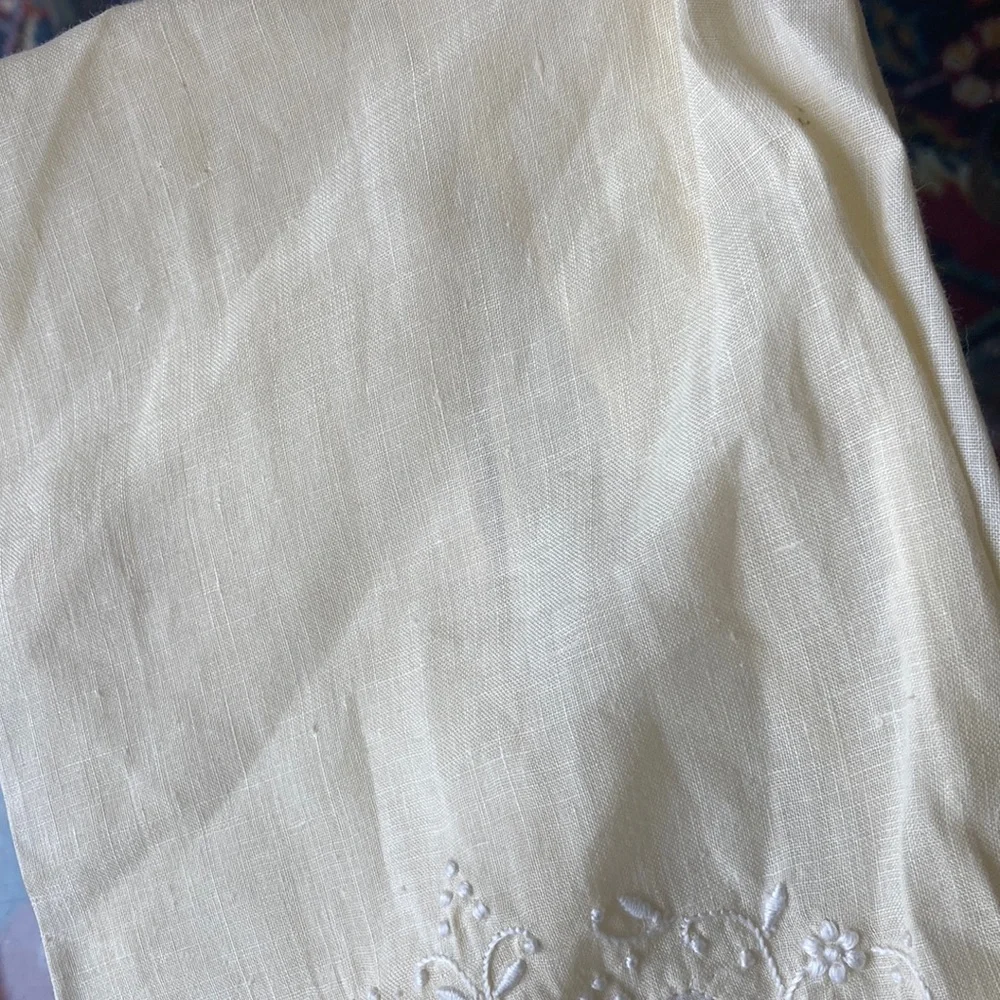 One fine linen embroidered tea towels. A muted butter yellow Vintage 1960s